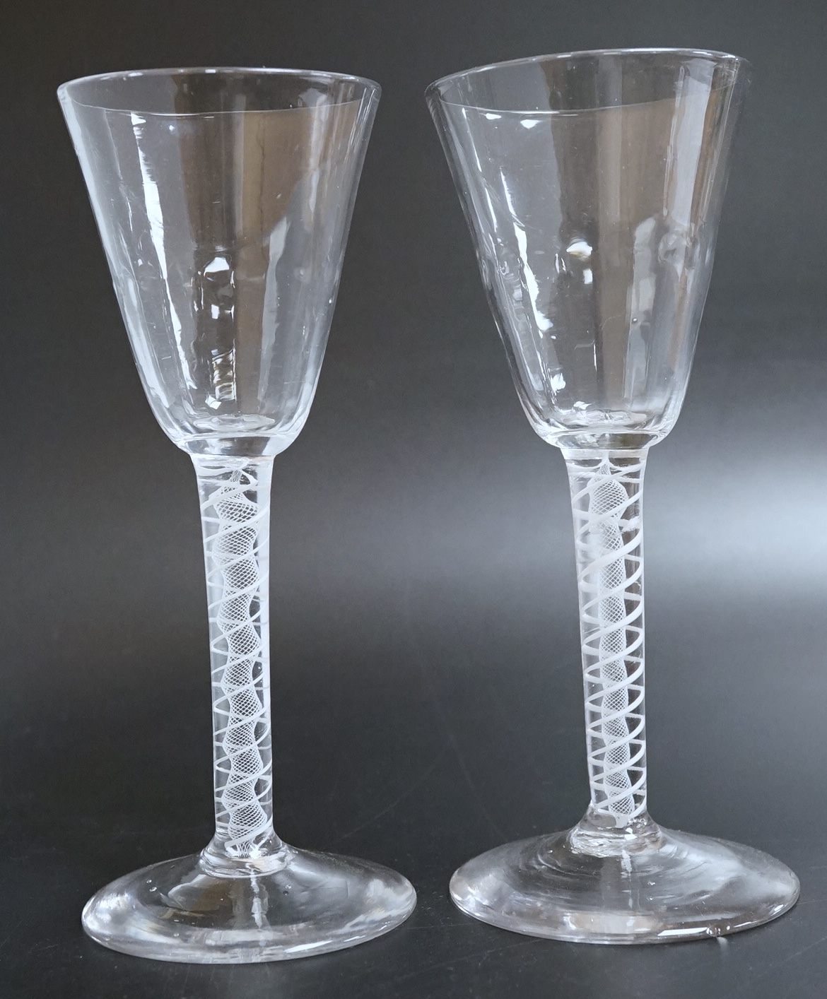 A near pair of opaque twist wine glasses, c.1760, 17.3cm high
